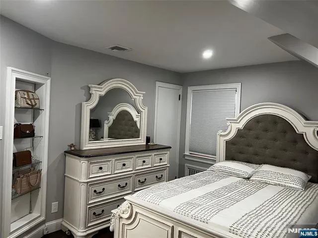 a bedroom with a bed and a stove top oven