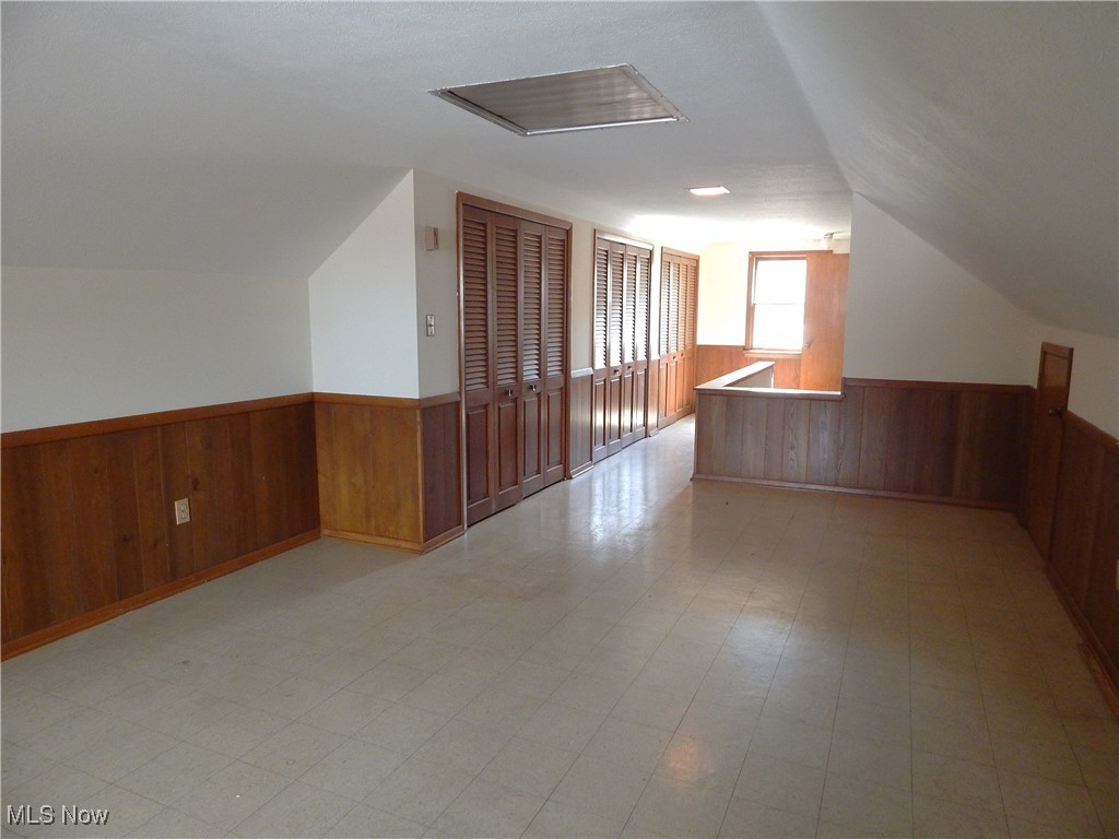 6990 Broadview Road Cleveland, OH 44134 - Photo 23 of 36 Bedroom up (opposite view) with a wainscoted wall, light floors, and vaulted ceiling with whole house fan.