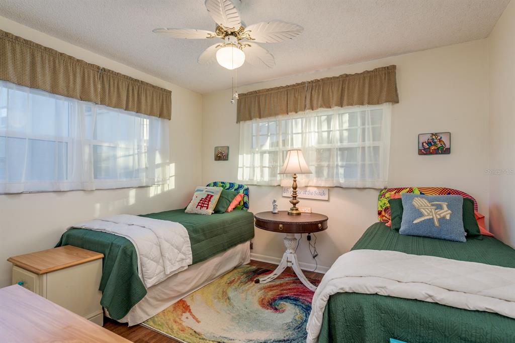 952 Virginia Street, Unit 105 Dunedin, FL 34698 - Photo 13 of 26 a bedroom with a bed and windows