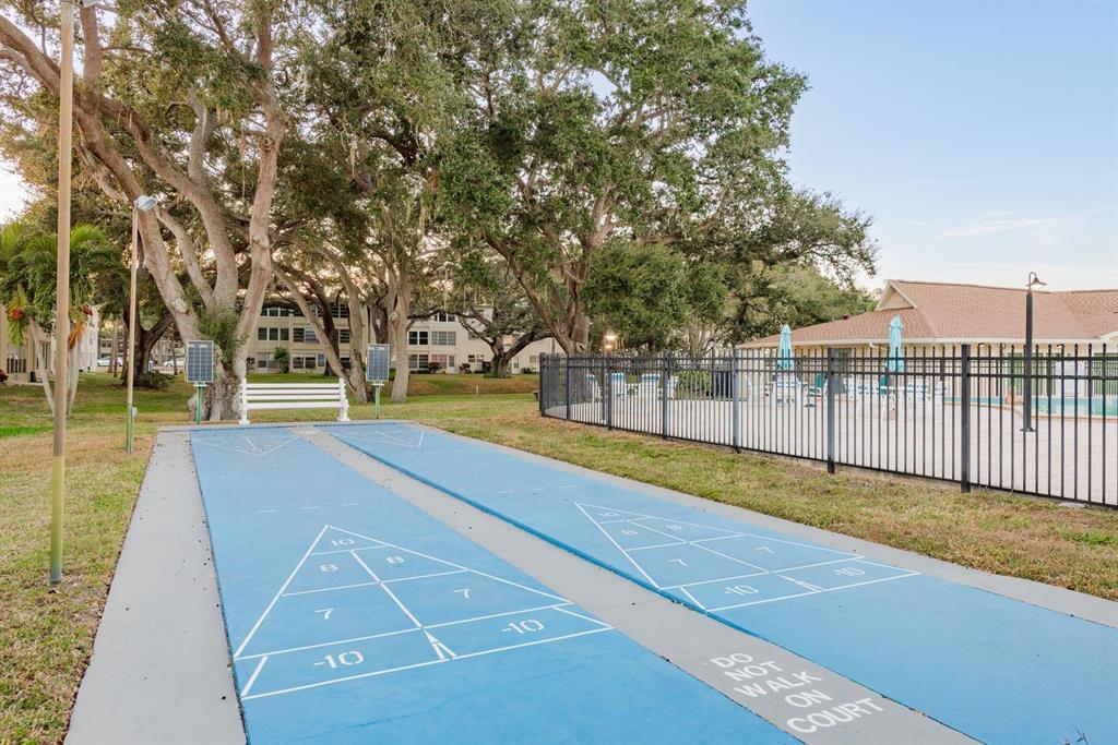 952 Virginia Street, Unit 105 Dunedin, FL 34698 - Photo 20 of 26 a view of a park with large trees