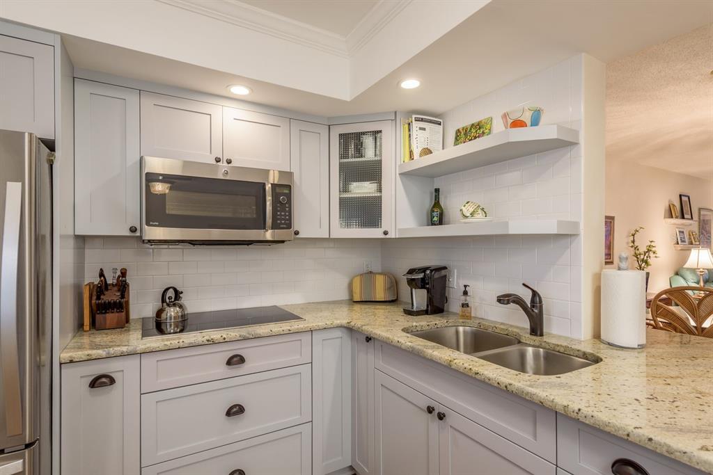 952 Virginia Street, Unit 105 Dunedin, FL 34698 - Photo 3 of 26 a kitchen with cabinets stainless steel appliances and a sink