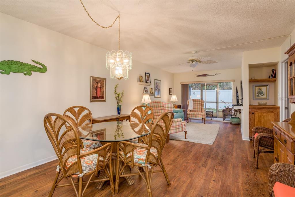952 Virginia Street, Unit 105 Dunedin, FL 34698 - Photo 5 of 26 a view of a dining room with furniture and wooden floor