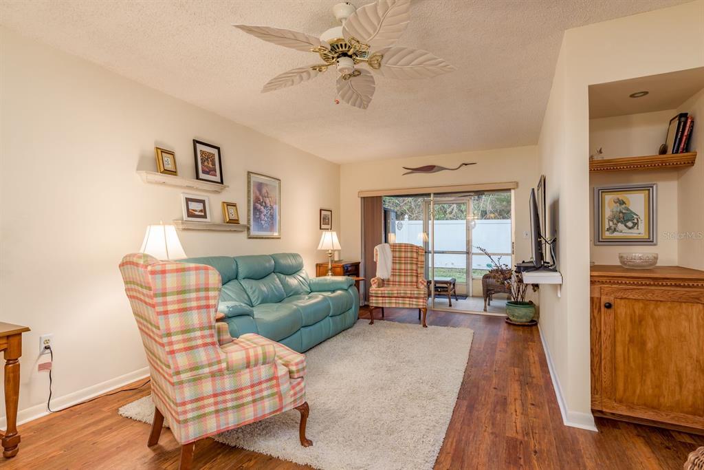 952 Virginia Street, Unit 105 Dunedin, FL 34698 - Photo 6 of 26 a living room with furniture and a fireplace