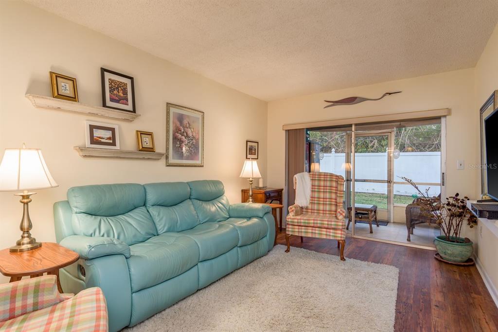 952 Virginia Street, Unit 105 Dunedin, FL 34698 - Photo 7 of 26 a living room with furniture and a large window