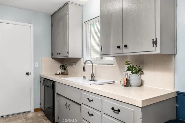 a kitchen with a sink cabinets and window
