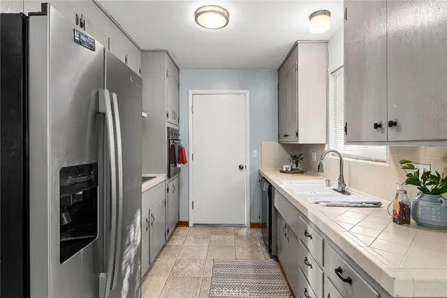 a kitchen with a sink and refrigerator