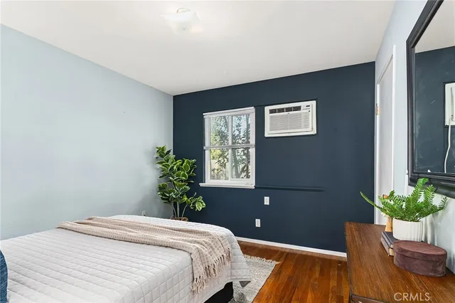 a bed room with a bed and a potted plant