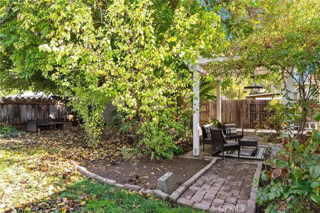a backyard of a house with table and chairs