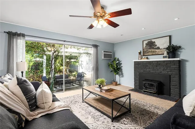 a living room with furniture fireplace and a large window