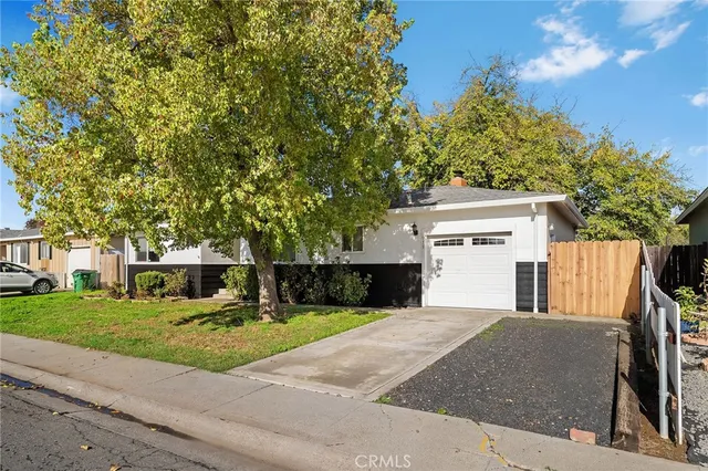 a view of a house with a yard and tree s