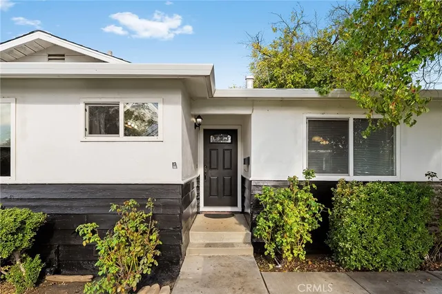 a front view of a house with a garden