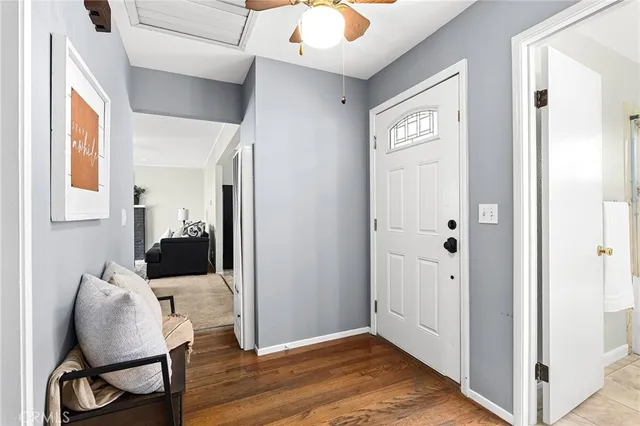 a view of a hallway with wooden floor and furniture