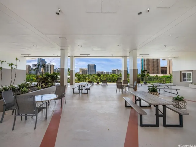 a room with lots of furniture and a potted plant