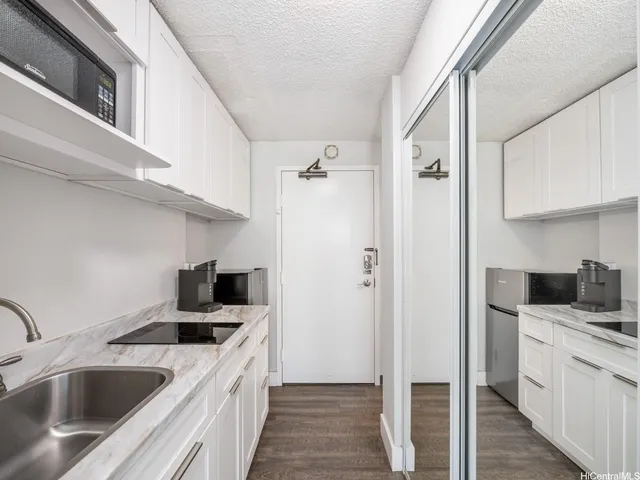 a kitchen with a sink cabinets and refrigerator
