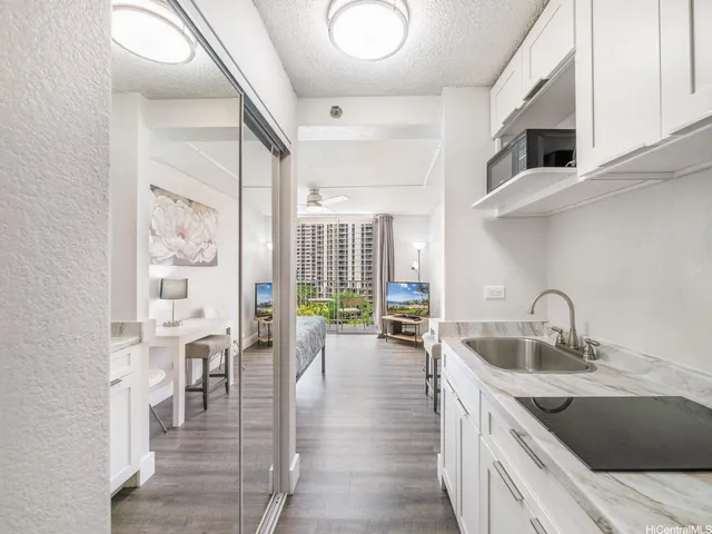 a kitchen with stainless steel appliances granite countertop a sink and cabinets