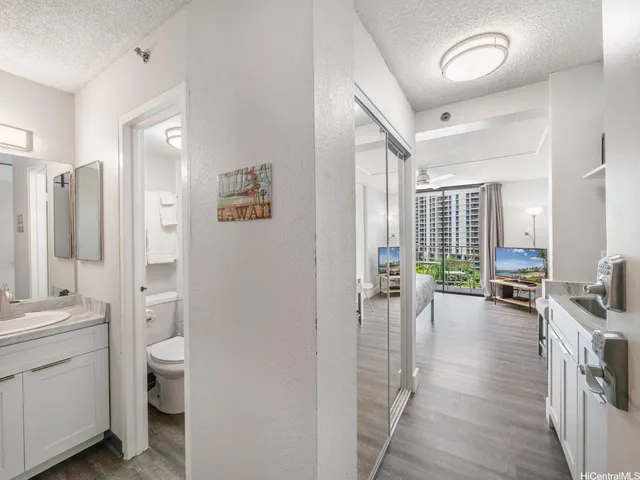 a bathroom with a toilet a sink and a mirror