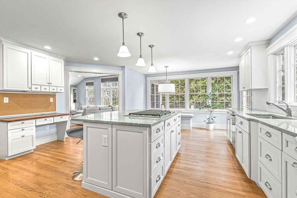 24 Birch Road Wellesley, MA 02482 - Photo 12 of 40 a large kitchen with granite countertop a stove top oven a sink a dining table and chairs
