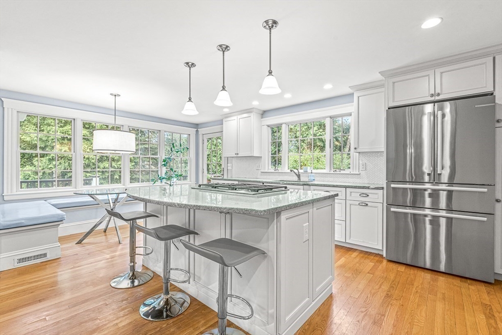 24 Birch Road Wellesley, MA 02482 - Photo 13 of 40 a kitchen with stainless steel appliances granite countertop a stove and a refrigerator