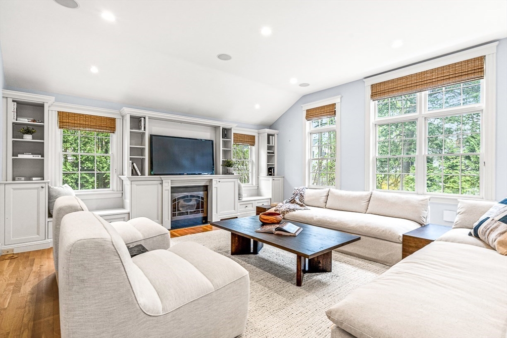 24 Birch Road Wellesley, MA 02482 - Photo 18 of 40 a living room with furniture a large window and a flat screen tv