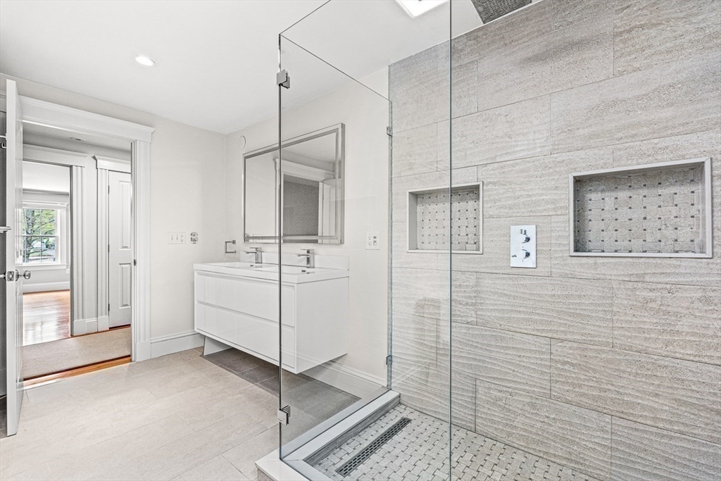 24 Birch Road Wellesley, MA 02482 - Photo 24 of 40 a bathroom with a sink a mirror and shower