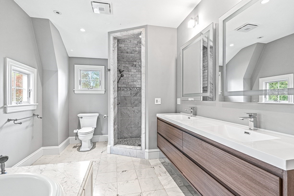 24 Birch Road Wellesley, MA 02482 - Photo 28 of 40 a spacious bathroom with a double vanity sink toilet and a mirror