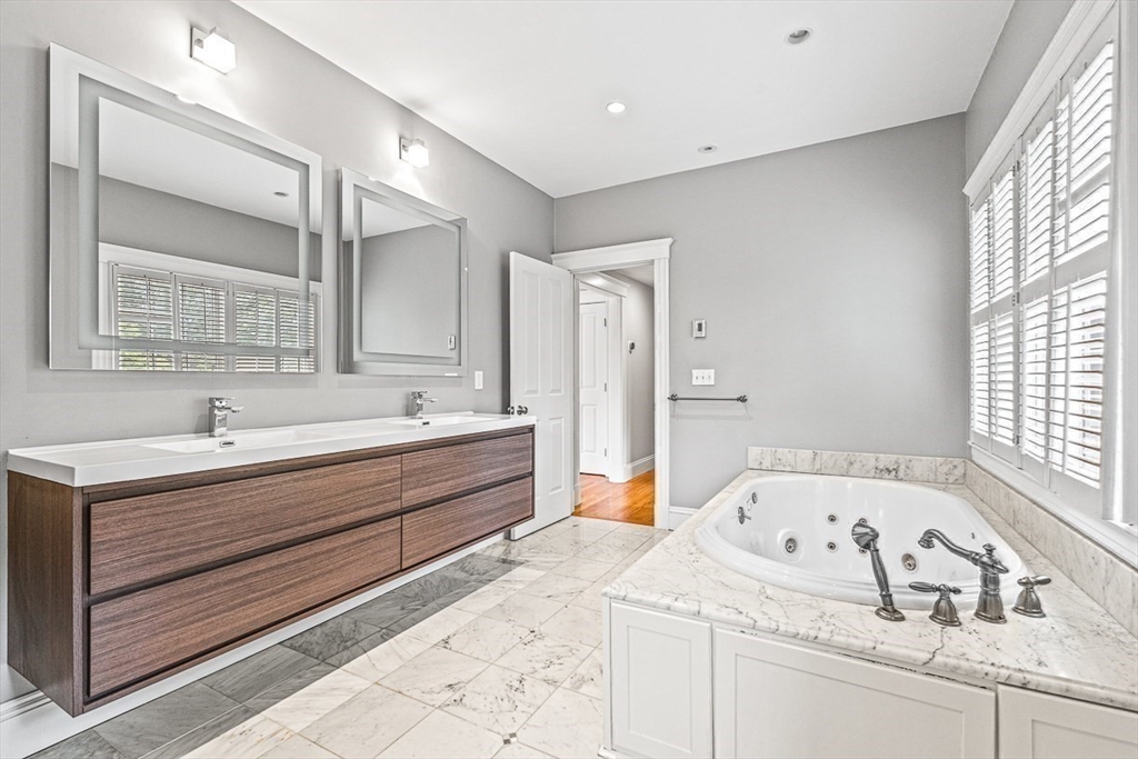 24 Birch Road Wellesley, MA 02482 - Photo 29 of 40 a bathroom with a tub sink and mirror