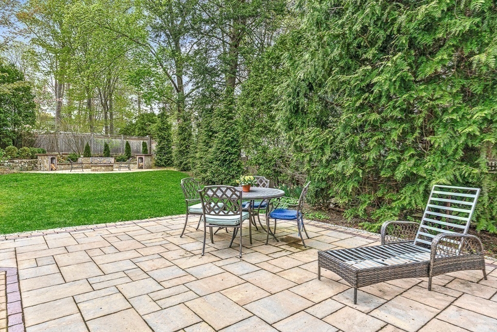 24 Birch Road Wellesley, MA 02482 - Photo 35 of 40 a view of a chairs and tables in the backyard