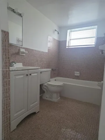 a front view of a building with potted plants