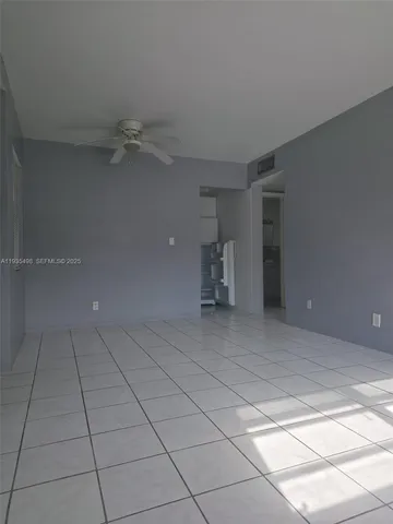 a view of an empty room and a window