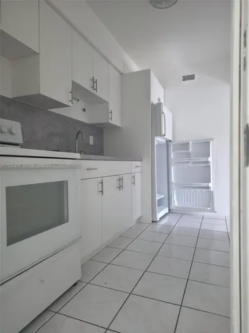a kitchen with cabinets and appliances