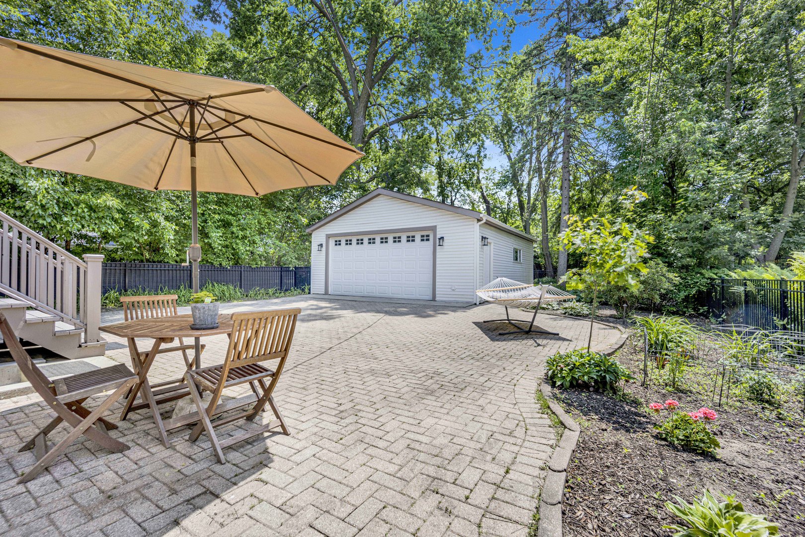 103 Pine Avenue Riverside, IL 60546 - Photo 27 of 42 a view of a chairs and table under an umbrella in backyard