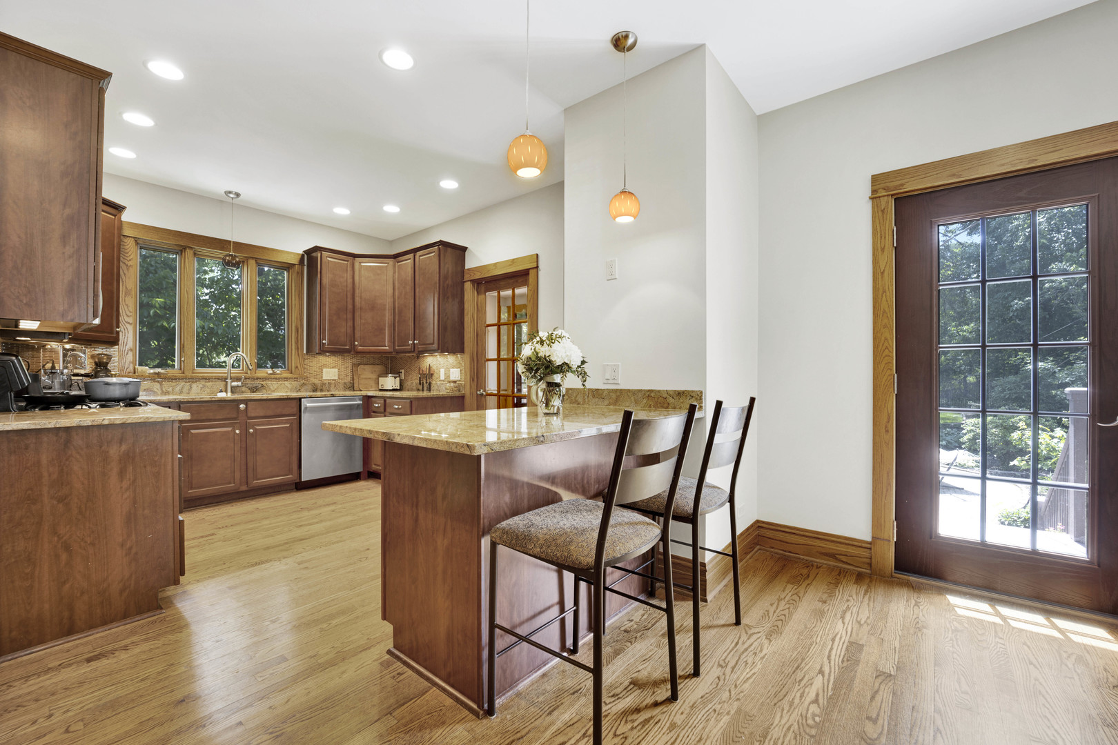 103 Pine Avenue Riverside, IL 60546 - Photo 9 of 42 a kitchen with a table chairs sink and cabinets
