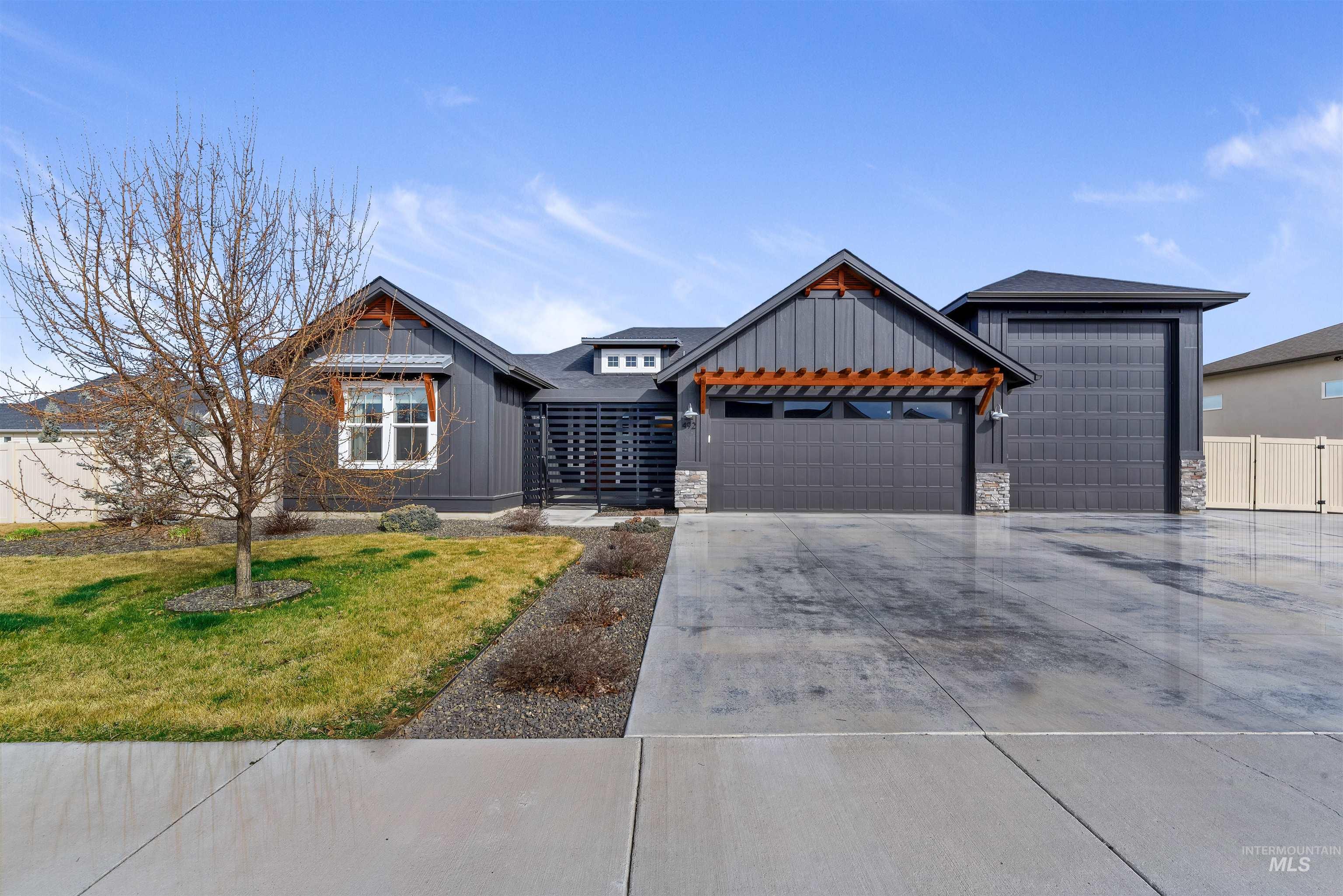 492 Applecreek Street Middleton, ID 83644 - Photo 1 of 1 View of front of home with board and batten siding, stone siding, a garage, and a front yard