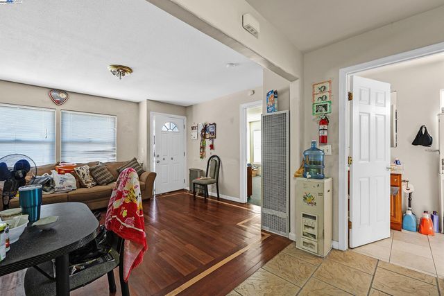 a living room with furniture a window and a wooden table