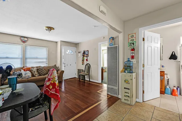 a living room with furniture a window and a wooden table