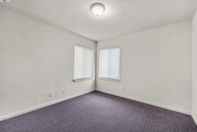 an empty room with a empty space and windows