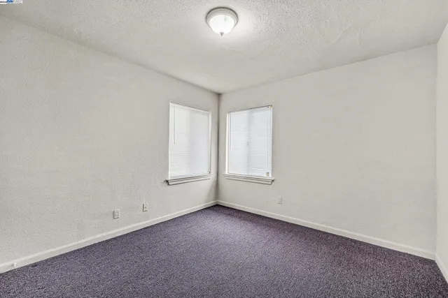 an empty room with a empty space and windows