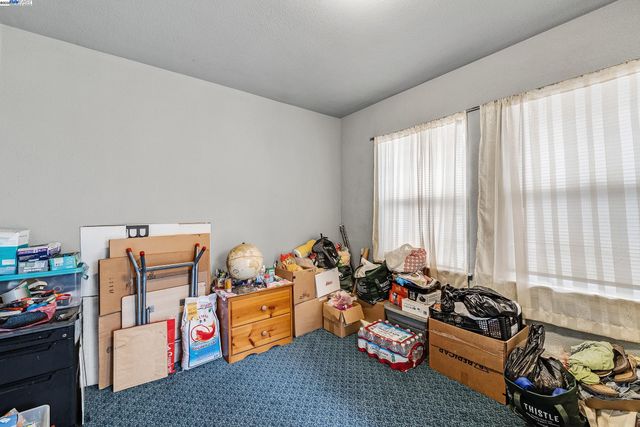 a bedroom with furniture toys and a large window