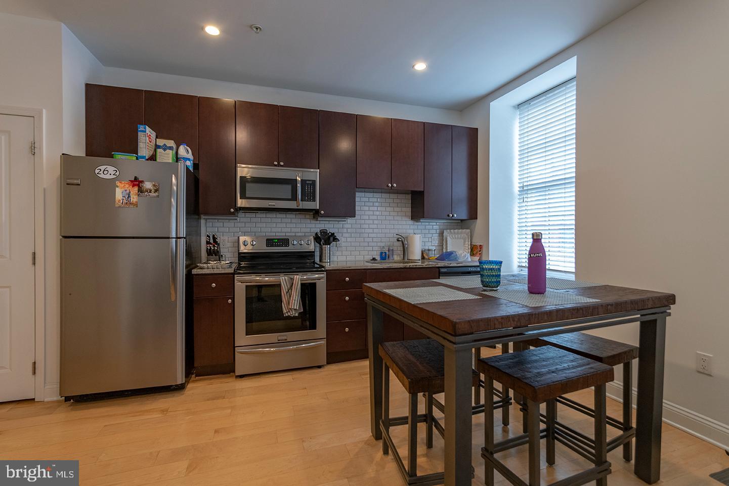 1311 Spruce Street, Unit 301 Philadelphia, PA 19107 - Photo 2 of 7 a kitchen with a refrigerator and a stove top oven