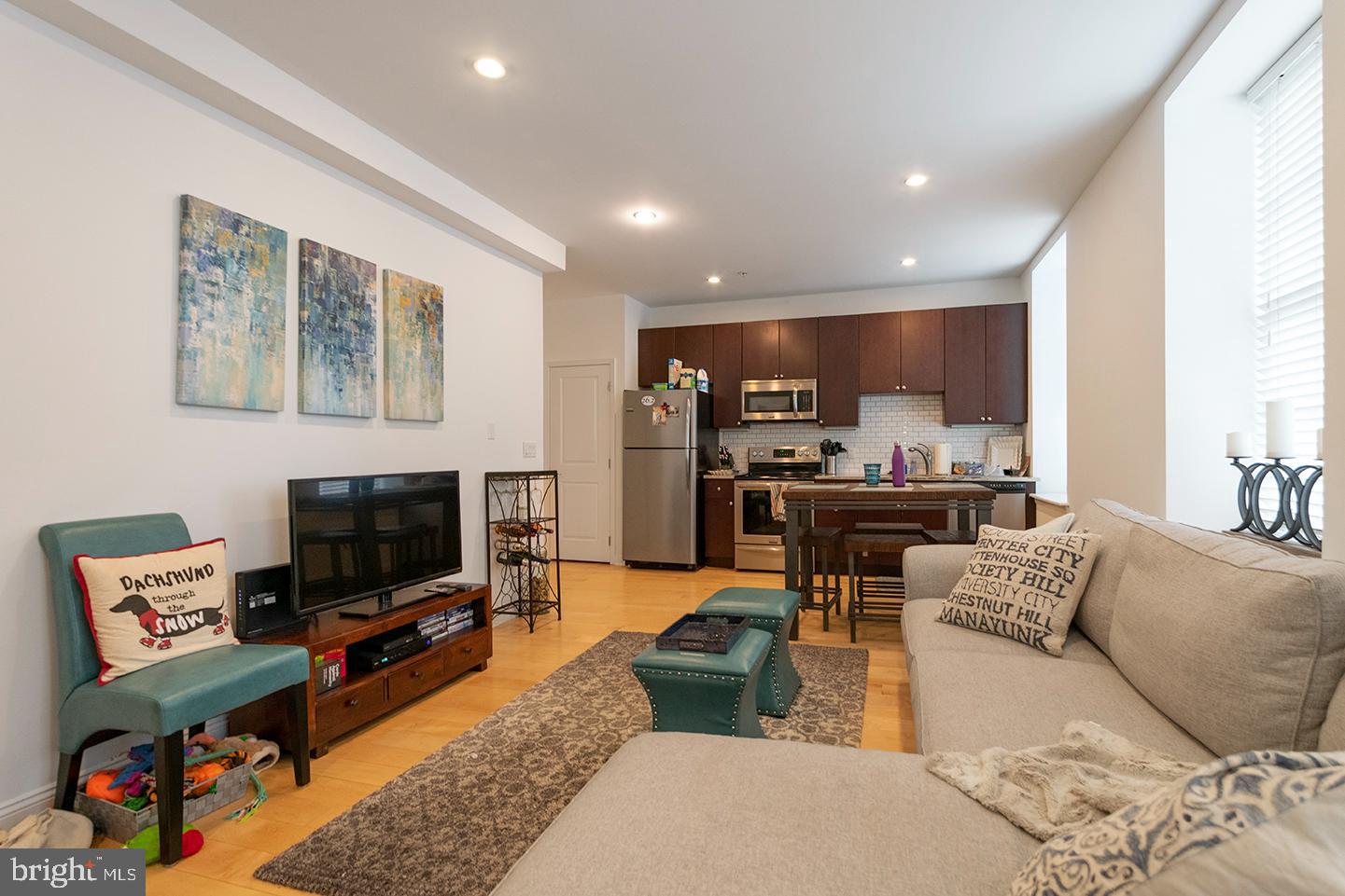1311 Spruce Street, Unit 301 Philadelphia, PA 19107 - Photo 5 of 7 a living room with furniture and a flat screen tv