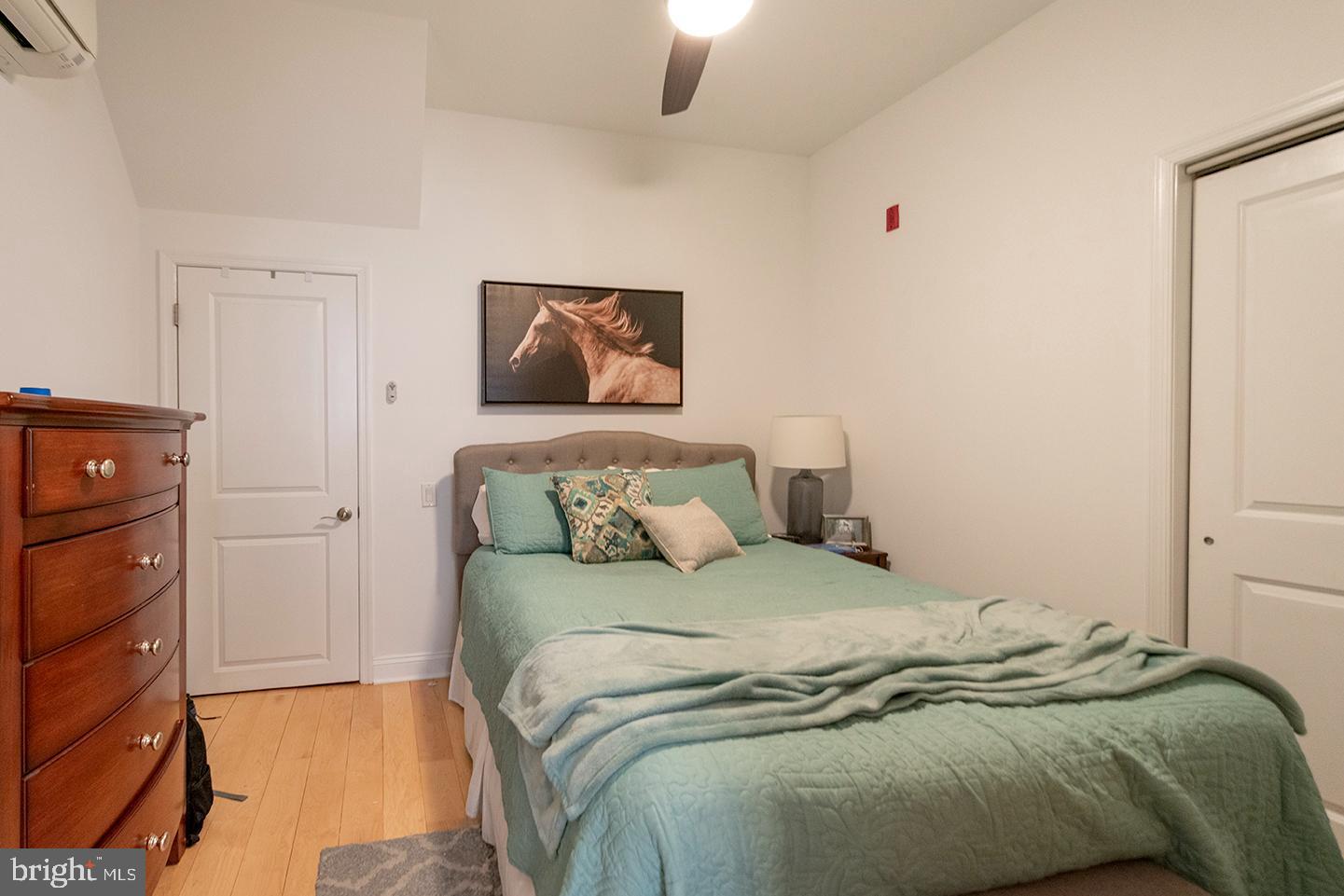 1311 Spruce Street, Unit 301 Philadelphia, PA 19107 - Photo 6 of 7 a bedroom with a bed and a painting on the wall
