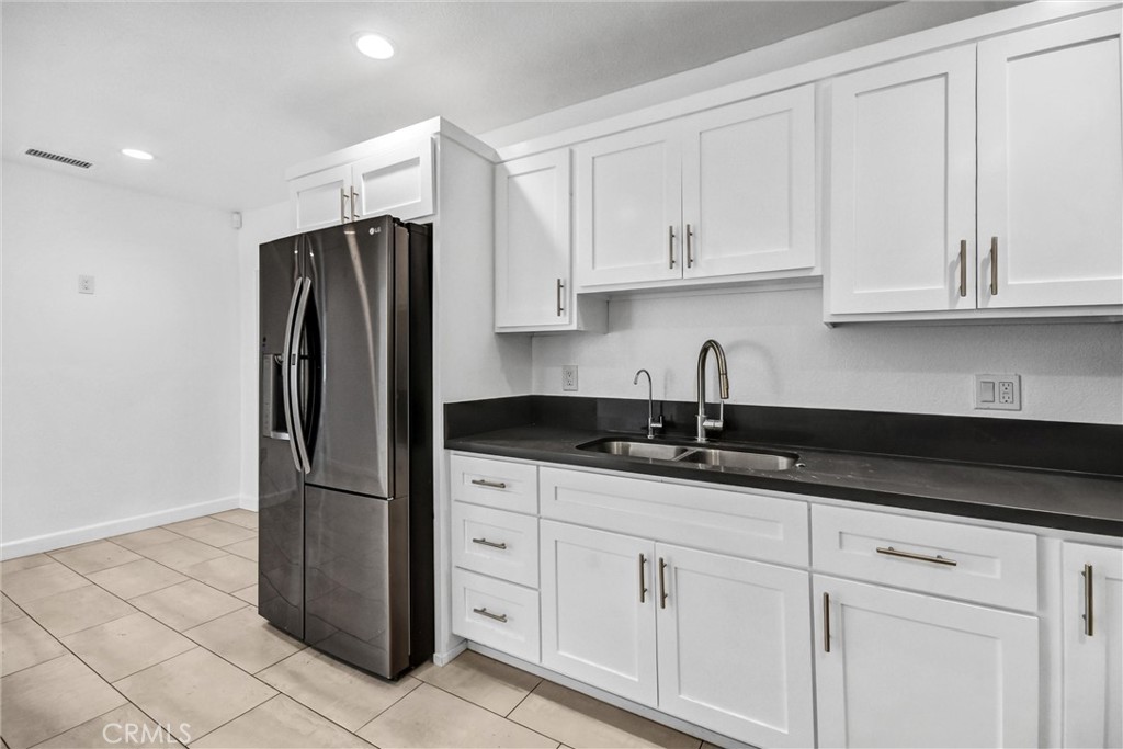 3913 Walnut Street Baldwin Park, CA 91706 - Photo 12 of 25 a kitchen with granite countertop a refrigerator sink and cabinets