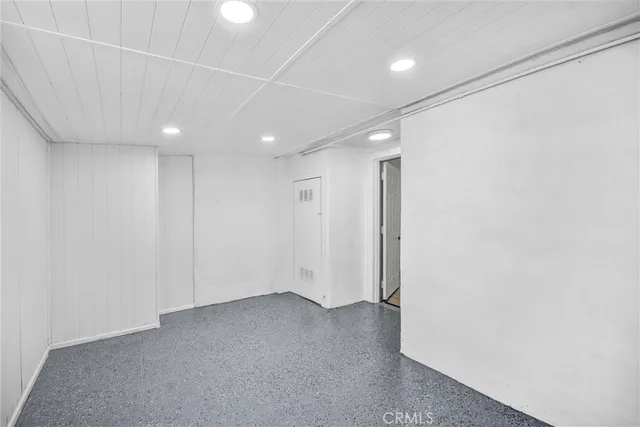 a view of a patio with a table and chairs and potted plants