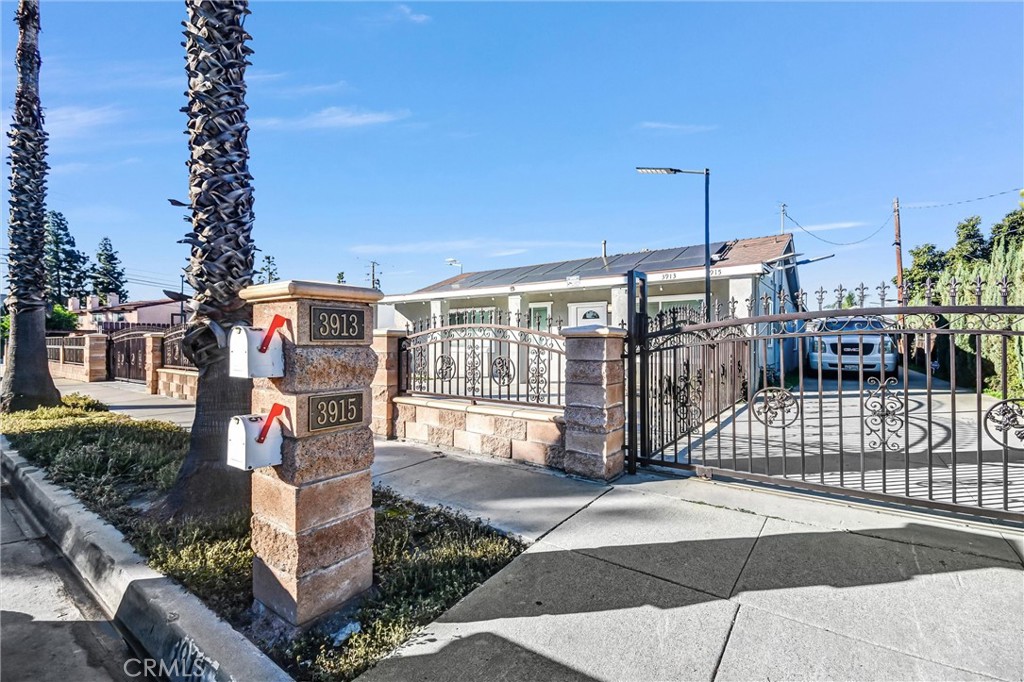 3913 Walnut Street Baldwin Park, CA 91706 - Photo 3 of 25 a street view with tall buildings and a yard