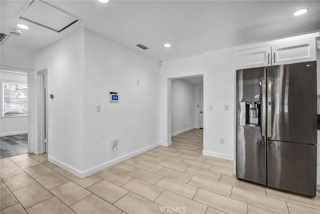 3913 Walnut Street Baldwin Park, CA 91706 - Photo 8 of 25 a view of a refrigerator in kitchen and an empty room