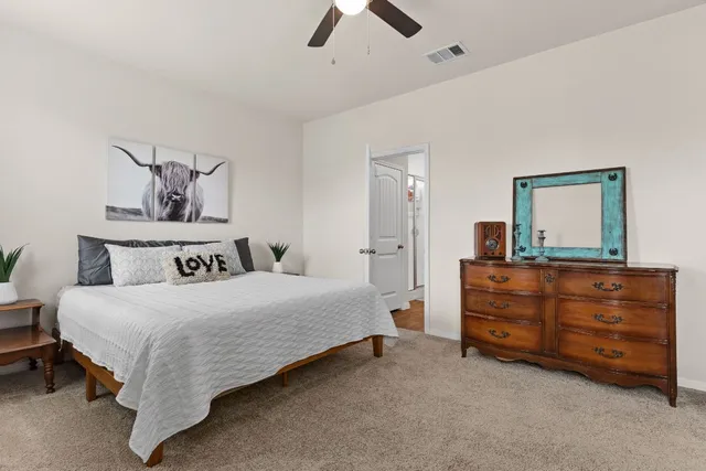 a blue bed sitting in a room next to a window with a projector
