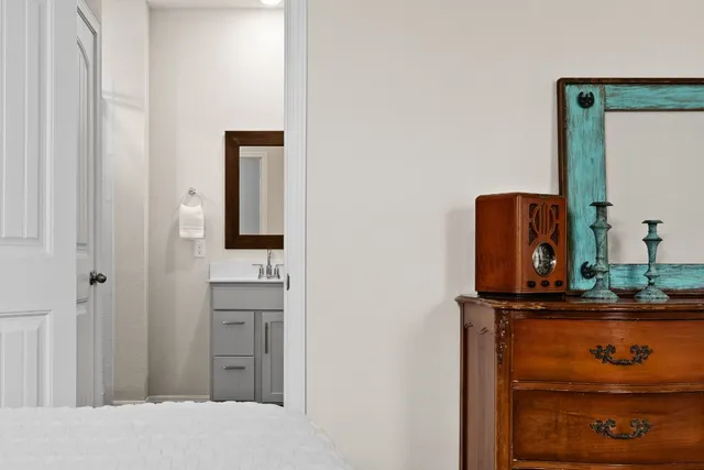 a bedroom with a large bed and ceiling fan