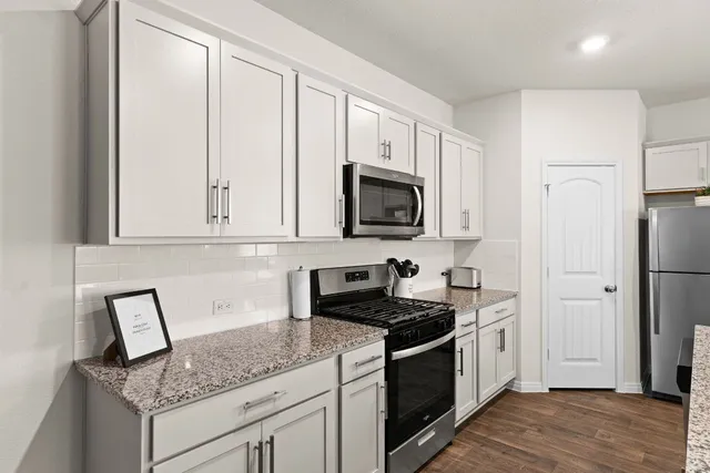 a view of a kitchen counter top a sink and a chandelier