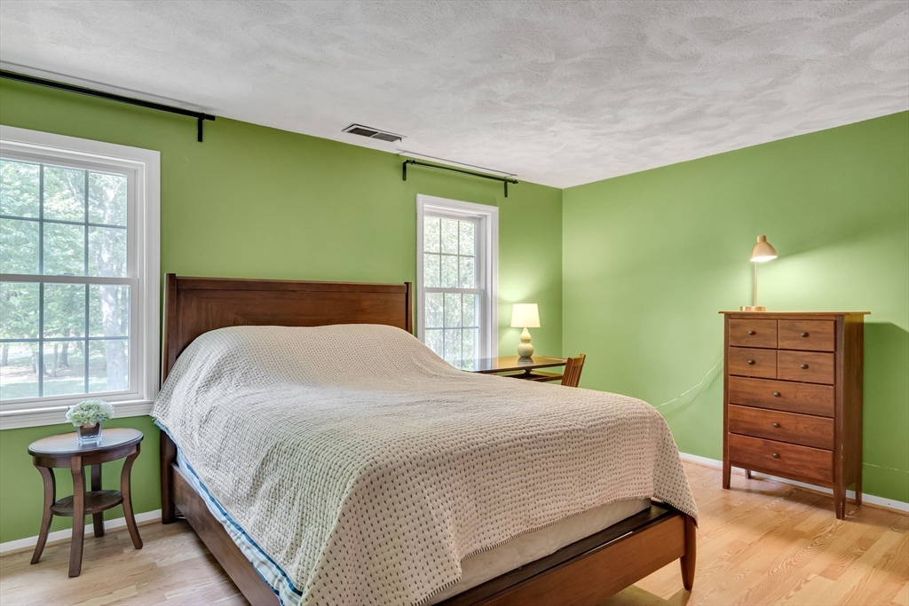 58 MacIntosh Lane, Unit 58 Boxborough, MA 01719 - Photo 15 of 23 a bedroom with a bed and a dresser next to a window