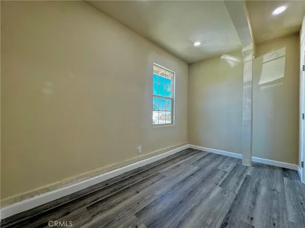 a view of room with window and hardwood floor